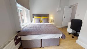 a bedroom with a large bed and a window at 1 Castle Yard in Coventry