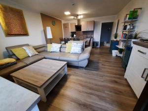 a living room with two couches and a table at Appartement 13 im Haus Dreisessel in Haidmühle