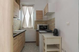 a small kitchen with a sink and a microwave at One Comfy Studio in Kallithea in Athens