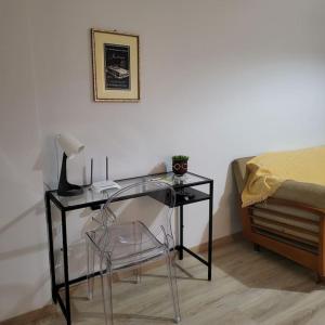 a desk with a lamp and a chair next to a bed at BEAUTIFUL APARTMENT IN VERIA in Veria