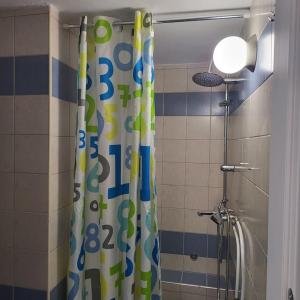 a bathroom with a shower with a shower curtain with numbers at BEAUTIFUL APARTMENT IN VERIA in Veria