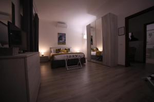 a bedroom with a bed and a room with a mirror at Appia Antica Guest House in Rome