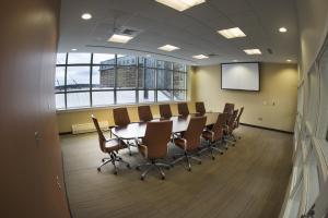 a conference room with a table and chairs and a screen at Memorial University in St. John's +50 photos