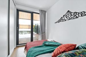 Łóżko lub łóżka w pokoju w obiekcie Apartament Morskie Oko Odkryj Zakopane