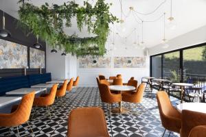 a dining room with tables and chairs and windows at The Pheasant Inn in Grange Over Sands