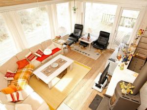 an overhead view of a living room with a couch and chairs at 8 person holiday home in Pandrup in Blokhus