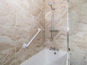 a shower with a white tub in a bathroom at 38 Carrowhubbock Holiday Village in Enniscrone