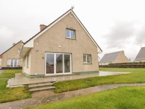 a house with a large window on the front of it at 38 Carrowhubbock Holiday Village in Enniscrone