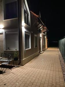 an empty street at night with a building at IHB-Inter House of Balaton in Zamárdi