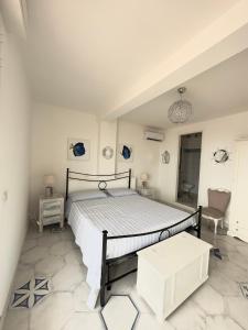a bedroom with a bed and a table and a chair at The RoofPort in San Felice Circeo