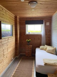 a bedroom with a bed in a wooden cabin at 3ART recreation in Tromsø