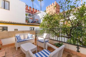 セビリアにあるAlcazar Pool Villa by Valcambreのバルコニーに椅子とテーブルが置かれたパティオ