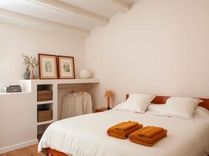 a bedroom with a bed with two towels on it at Les Canes 2 in Aiguafreda