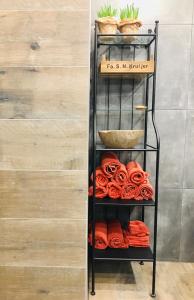 a black towel rack with red towels on it at Studio Mika met whirlpool! in Julianadorp