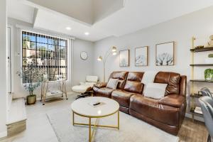 a living room with a leather couch and a table at Midtown Oasis in Phoenix