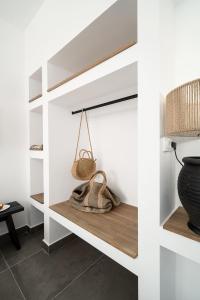 a shelf with a purse and a basket on it at Stella Luxury Apartments in Agia Galini