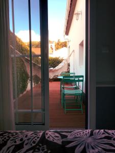 a door leading to a patio with a table and chairs at Modern room (with deck) in Povoação