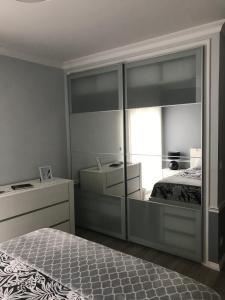 a bedroom with a bed and a large glass wall at Modern room (with deck) in Povoação