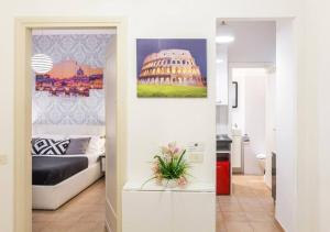 a room with a bed and a picture of the coliseum at Navona Home in Rome