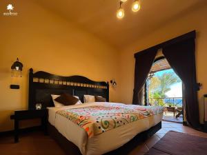 a bedroom with a large bed with a view of the ocean at Dahab Paradise in Dahab