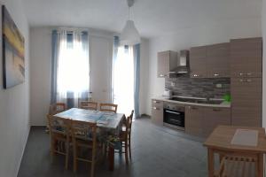 a kitchen and dining room with a table and chairs at La casa accanto in Rio nellʼElba