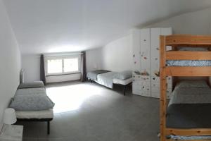 a bedroom with two bunk beds and a window at La casa accanto in Rio nellʼElba