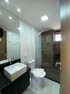 a bathroom with a sink and a toilet and a shower at Lindo flat no Maui Beach Residence C201 in Tamandaré