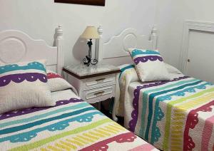 A bed or beds in a room at Casa duplex en chipiona