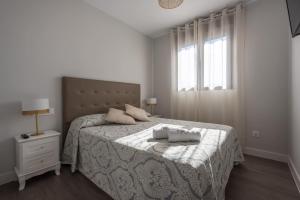 a bedroom with a bed with two towels on it at Apartamento Estepona I in Estepona