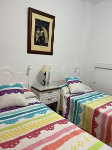 A bed or beds in a room at Casa duplex en chipiona