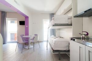 a room with a bed and a table with chairs at La casa dei tre pesci - Appartamento Lavarello in Torno