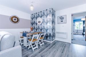a dining room and living room with a table and chairs at Stunning 2 Bed Apt By Greenstay Serviced Accommodation - Located in Formby Village - Perfect For SHORT & LONG STAYS - Couples, Friends & Families & Business Travellers All Welcome - Dog Friendly - 7 in Formby