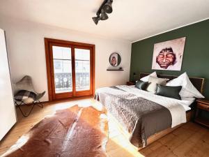 a bedroom with a large bed and a large window at 4 SEASON LODGE in Zell am See