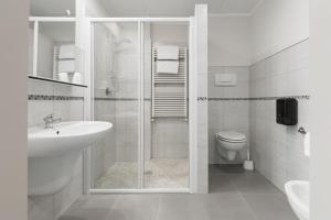 a bathroom with a shower and a sink and a toilet at Hotel Porta Palio in Verona