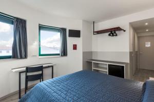 Posteľ alebo postele v izbe v ubytovaní Hotel Porta Palio