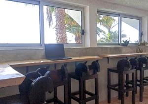 a classroom with a desk with a laptop computer on it at Porto Santo Destination in Porto Santo