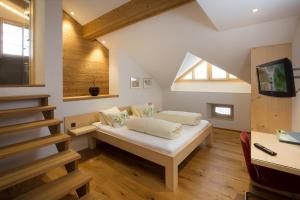 a room with a bed in a attic at Hotel Alpsu in Disentis