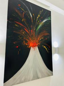 a painting of a flower on a wall at Roomors Of Naples - Sea View Apartment in Naples