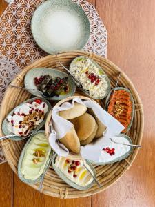 a basket filled with different types of food on a table at The Bunker House in Chopta