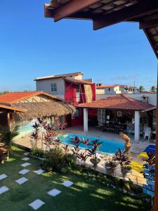 a view of a resort with a swimming pool at Pousada BANGALÔS SOL DE LAGOINHA in Lagoinha