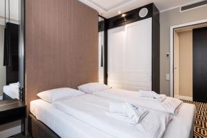Łóżko lub łóżka w pokoju w obiekcie Baltic Park Fort Promenada Apartment Świnoujście by Noclegi Renters