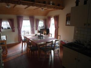a kitchen and dining room with a table and chairs at B&B De Pepper in Haaksbergen +22 photos