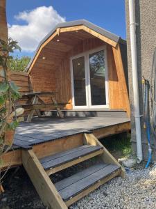 a tiny house with a porch and a table at Laity's Lodge in Penzance