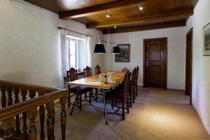 a dining room with a wooden table and chairs at Ferienhaus Alpenbichl - a74010 in Krün