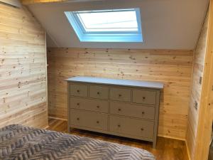 a bedroom with a bed and a skylight at Laity's Lodge in Penzance