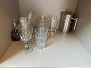 a group of clear glasses sitting on a shelf at Laity's Lodge in Penzance +14 photos