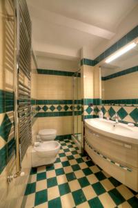 a bathroom with a tub and a toilet and a sink at Dama charming apartment 100m from Piazza del Campo in Siena