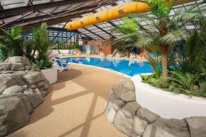 a pool in a resort with a surfboard above it at Marine Holiday Park D & S rental A in Rhyl