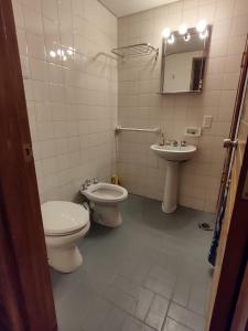 a bathroom with a toilet and a sink at Departamento Penitentes Mendoza in Los Penitentes