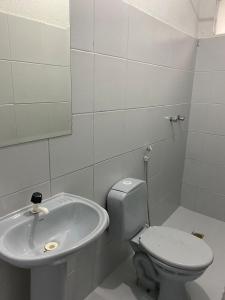 a bathroom with a toilet and a sink at GYN SUITES - SUITES EM GOIÂNIA GO in Goiânia